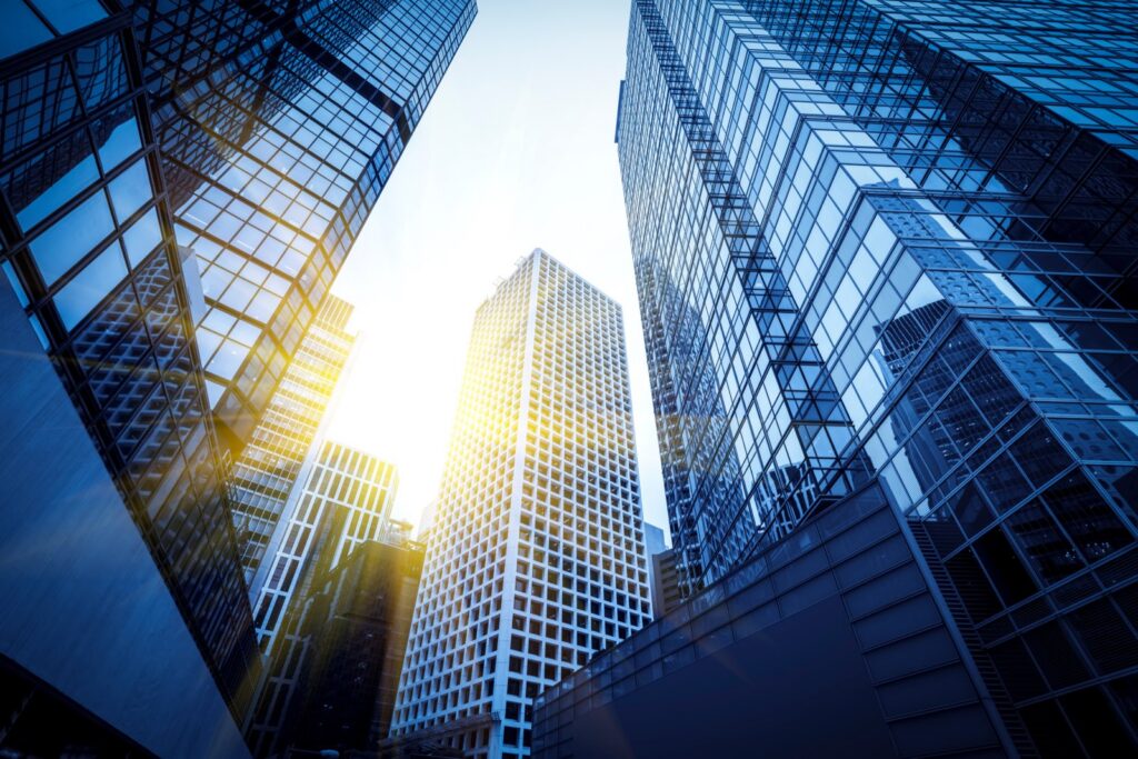 Modern glass office towers in a financial district viewed from below